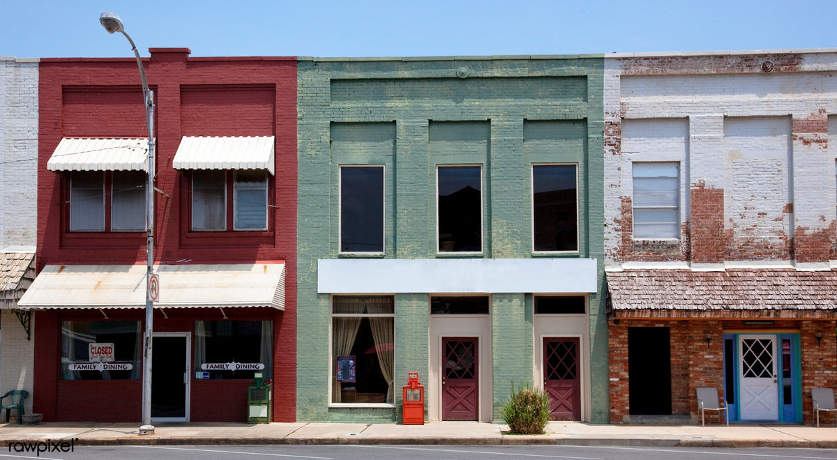 Historic downtown storefronts with vintage architecture featuring colorful shopfronts in mint green and red tones by Carol M. Highsmith (Library of Congress collection)